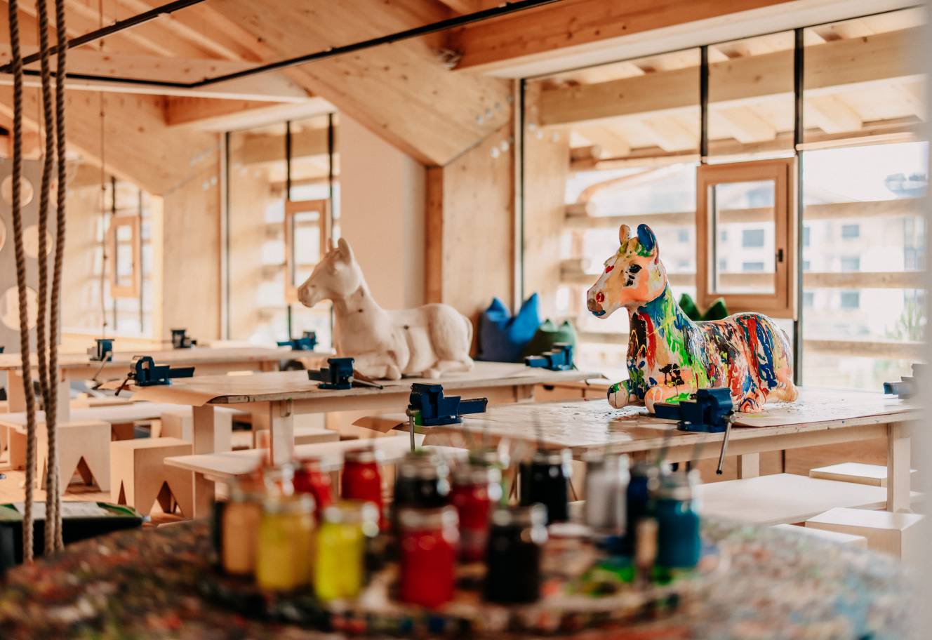  Creative workshop with horse statues on painting table