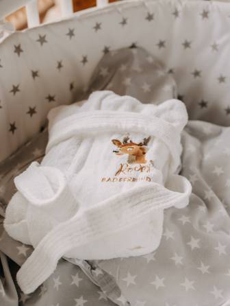 Baby sits in bed