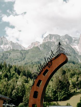 Riding stable in the summer with the mountains in the background