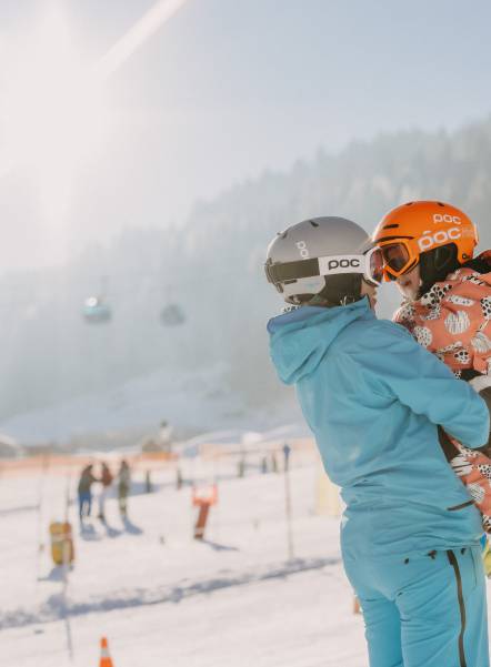  Person holding child in arms at ski resort