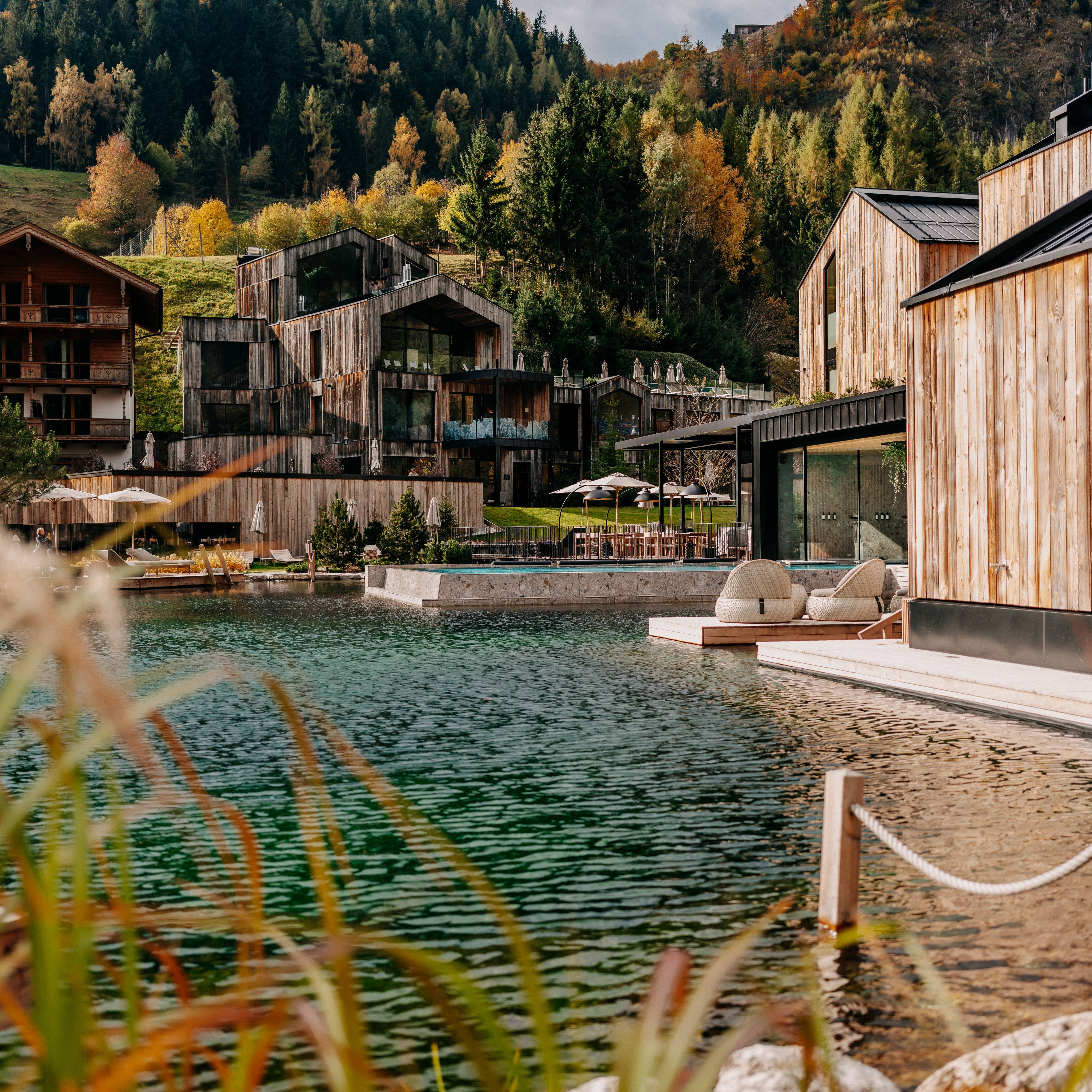 Bathing lake and lake house with a view of the mountains in early autumn