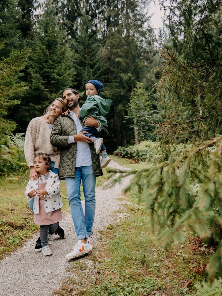Family is walking over the bridge in the Naturhotel Forsthofgut Austria