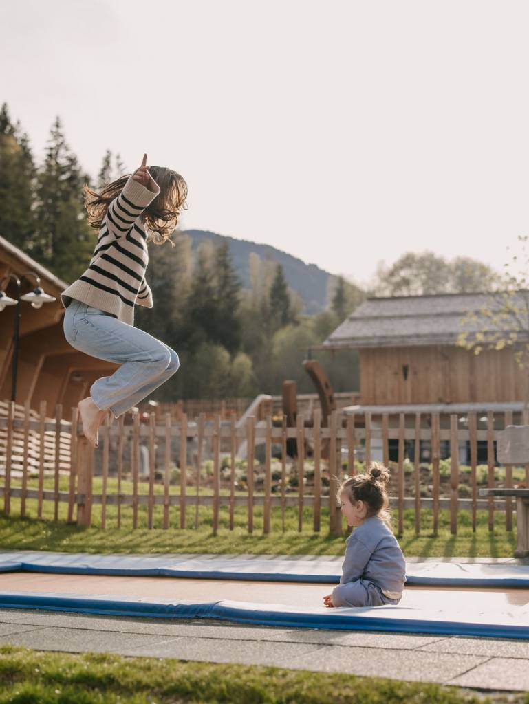 waldspielplatz mit Holzgeräten, Rutschen und einer Murmelbahn im Forsthofgut