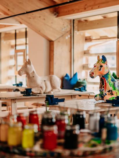 Creative workshop with horse statues on painting table