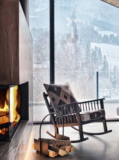 Rocking chair in front of a fireplace