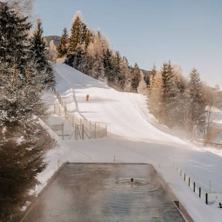Outdoor pool overlooking ski slope in winter