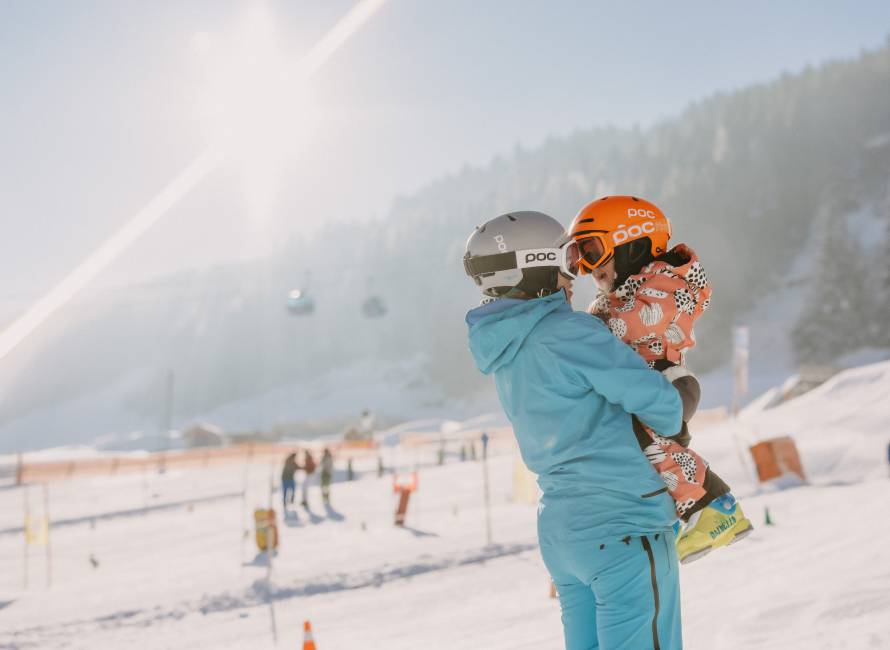  Person holding child in arms at ski resort