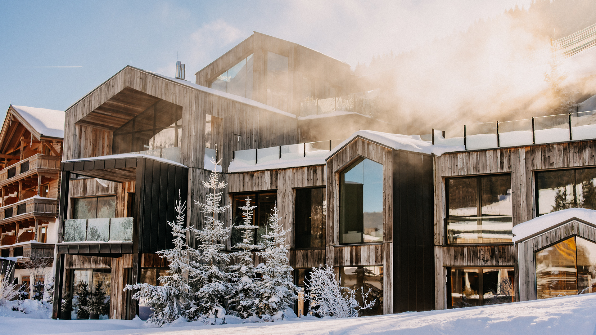 Exterior view of the Forsthofgut waldSPA in winter with snow-covered facade.
